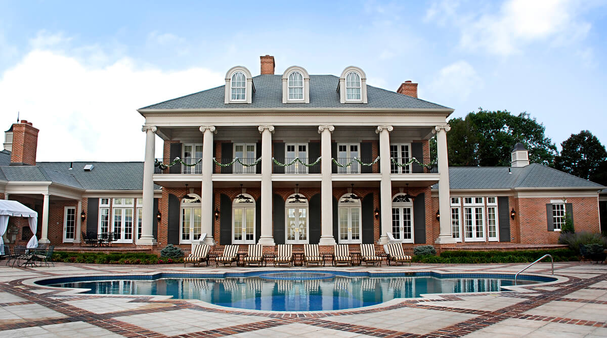 Rear Exterior Facade and In-Ground Swimming Pool at Antebellum Plantation Home in Higginsville, Missouri Designed by NSPJ Architects