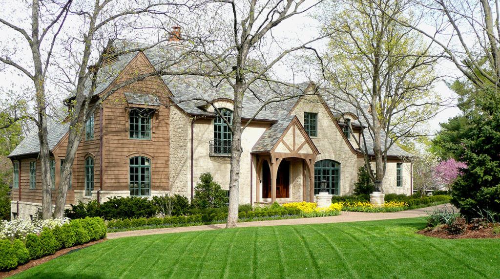 Exterior of Mission Hills, Kansas home designed in the style of an English manor. Architecture by NSPJ Architects.