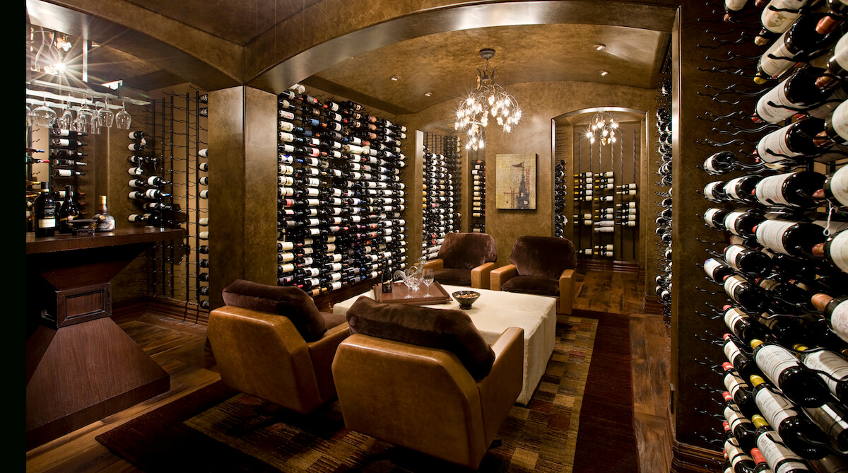 Wine cellar in private ski retreat in Park City, Utah. Features include floor-to-ceiling, climate-controlled wine storage, and theatre seating. Architecture by NSPJ Architects.