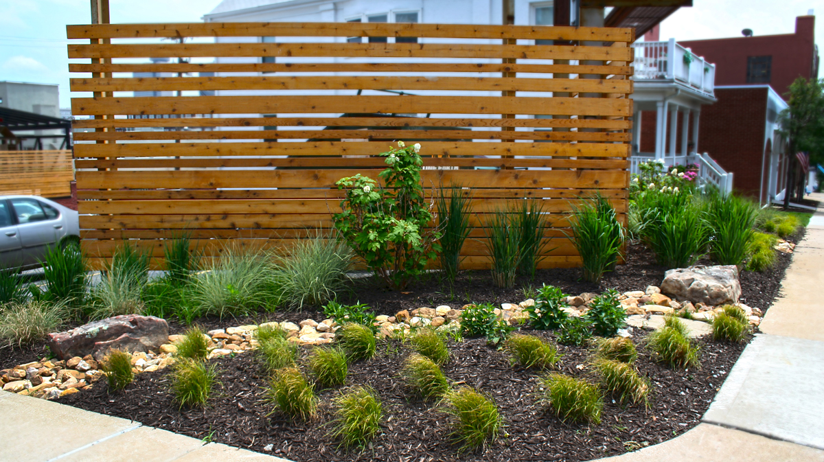 Exterior privacy fence and plantings at downtown Kansas City office. Landscape architecture by NSPJ Architects.