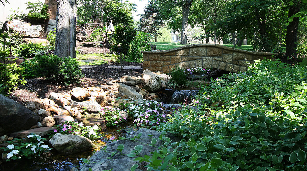 Stone Bridge in Secret Garden in Overland Park, Kansas Designed by NSPJ Architects