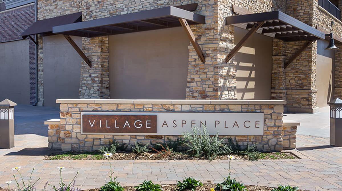 Monument sign for Village at Aspen Place, designed by NSPJ Architects