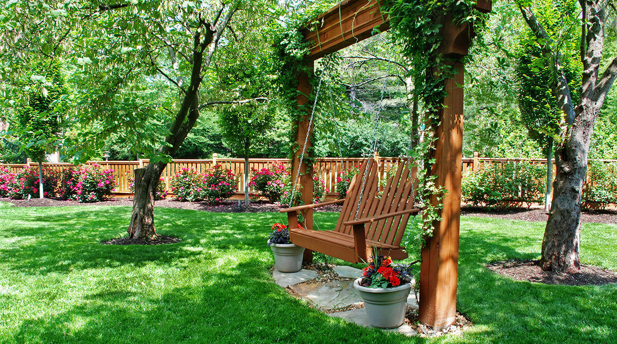 Backyard swing at Prairie Village, Kansas home. Landscape Architecture by NSPJ Architects.