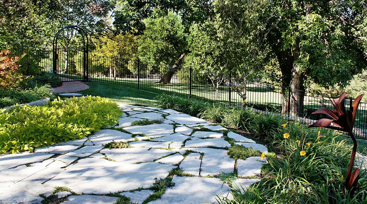 Stone pathway in formal Kansas City, Missouri home with formal landscape design by NSPJ Architects.