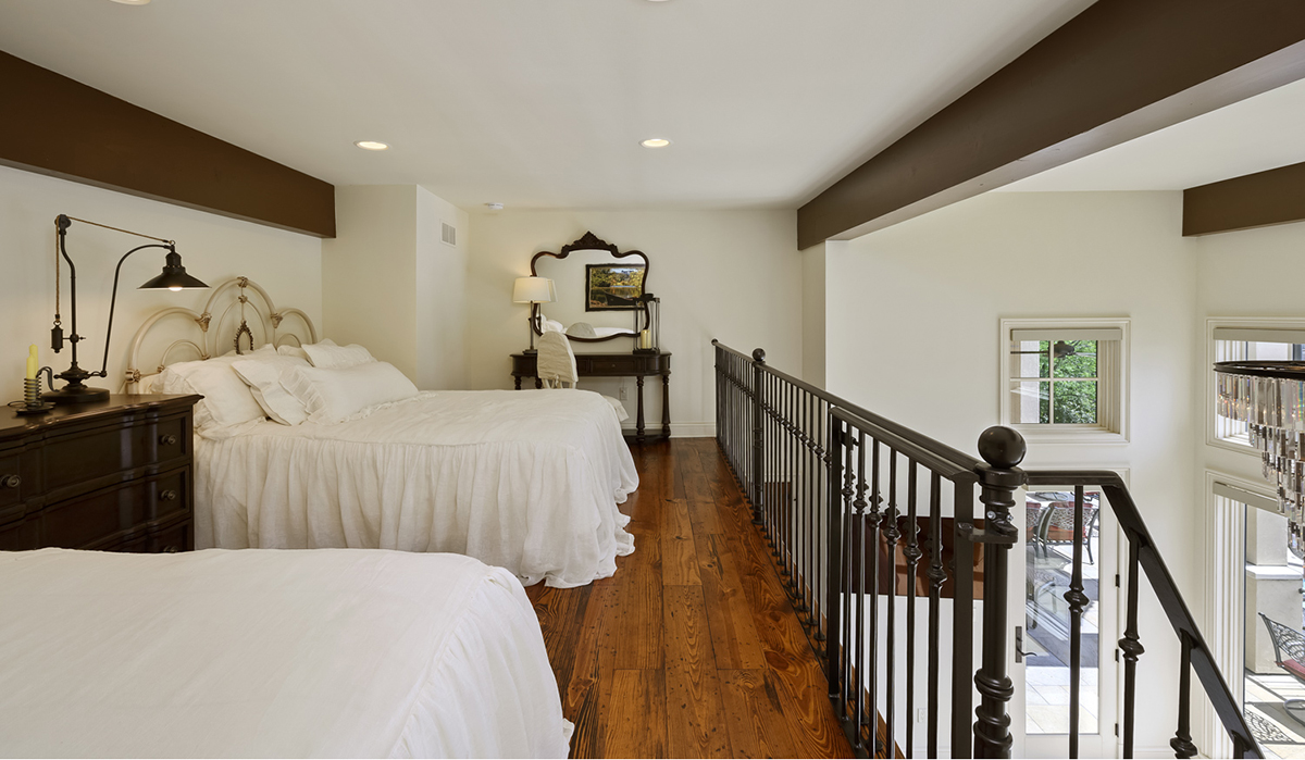 Guest Bedroom at the Lake of the Ozarks Luxurious Home designed by NSPJ Architects