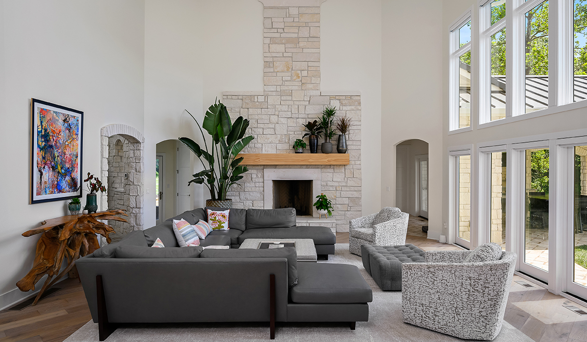 Modern Mediterranean Family room, high ceiling, stone fireplace, arched doorway