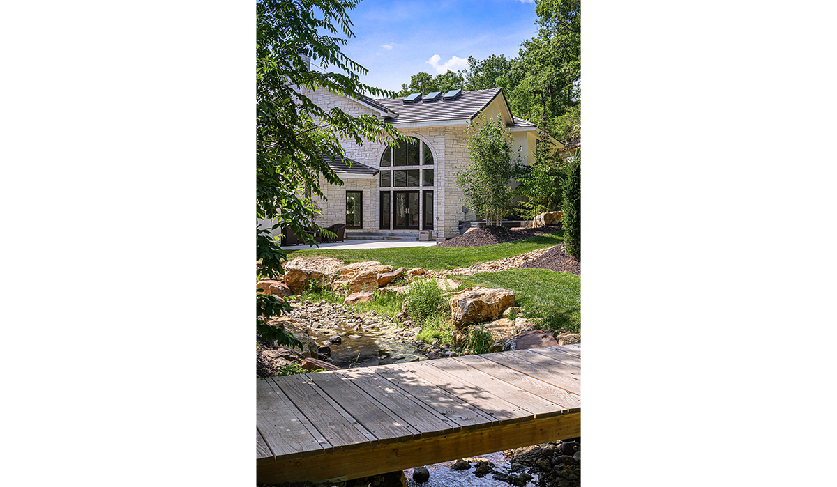 Modern Mediterranean Stone exterior arched window looking at home from dock