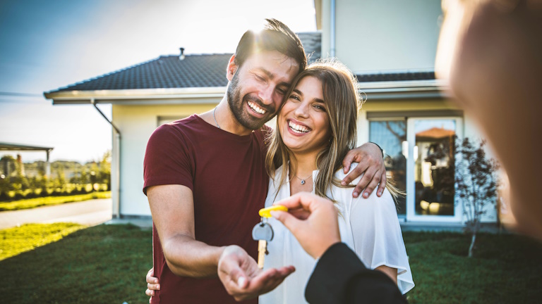 happy couple getting house keys